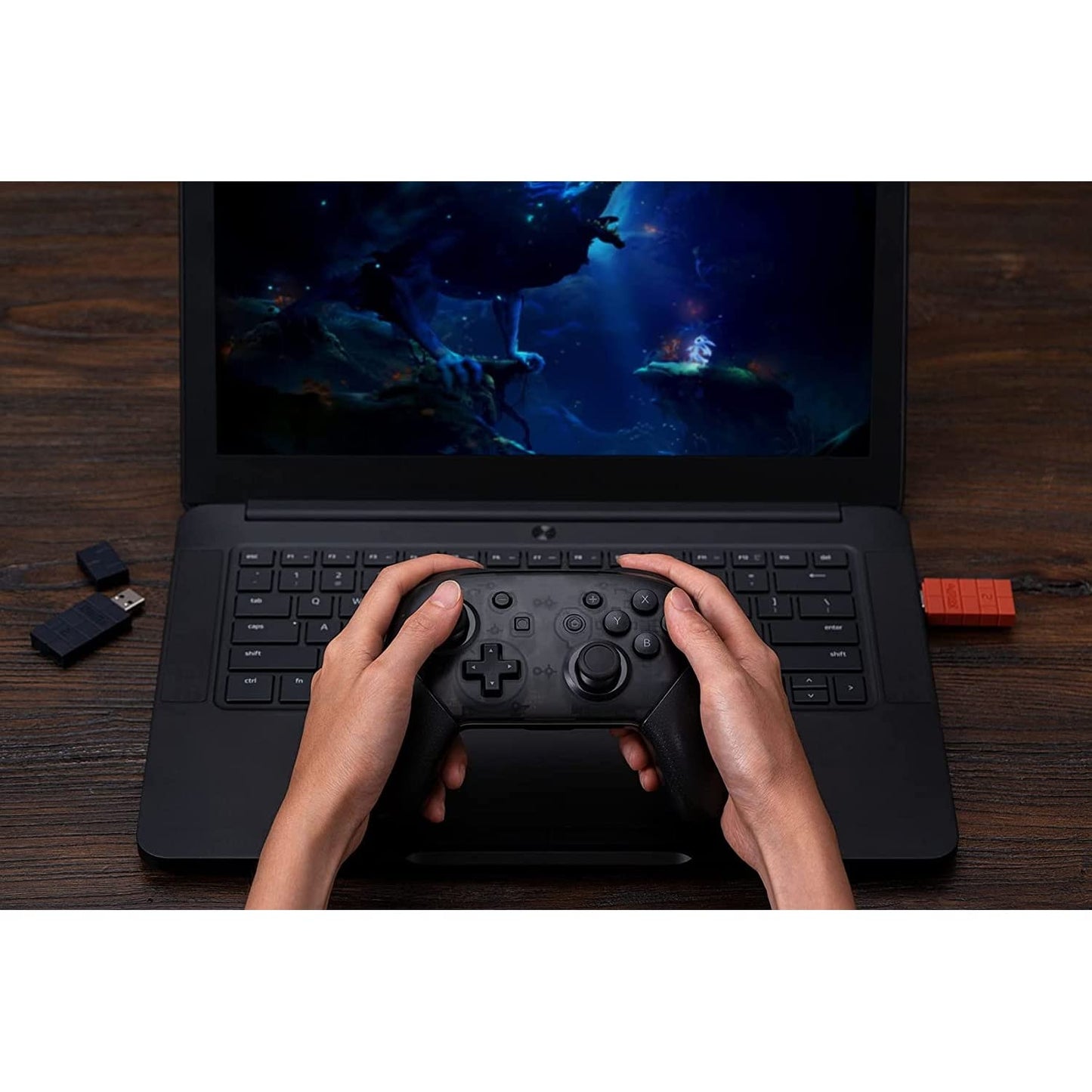 User playing a PC game wirelessly with a controller connected through the 8Bitdo Wireless Bluetooth Adapter 2 plugged into a laptop.