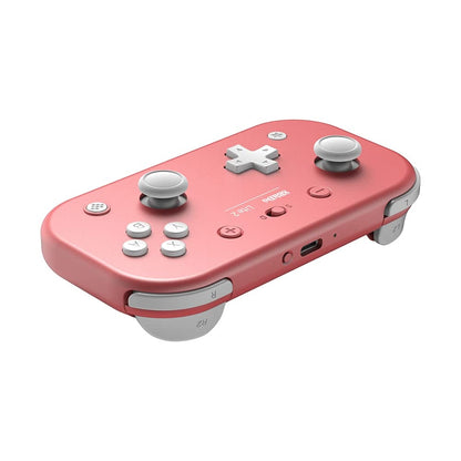 Angled view of 8BitDo Lite 2 pink controller showing joysticks, D-pad, face buttons, and shoulder triggers.