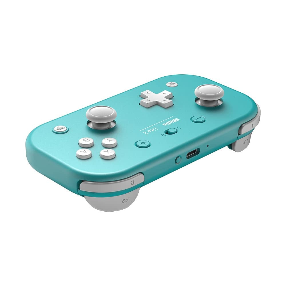 Angled view of 8BitDo Lite 2 turquoise controller showing joysticks, D-pad, buttons, and shoulder triggers.