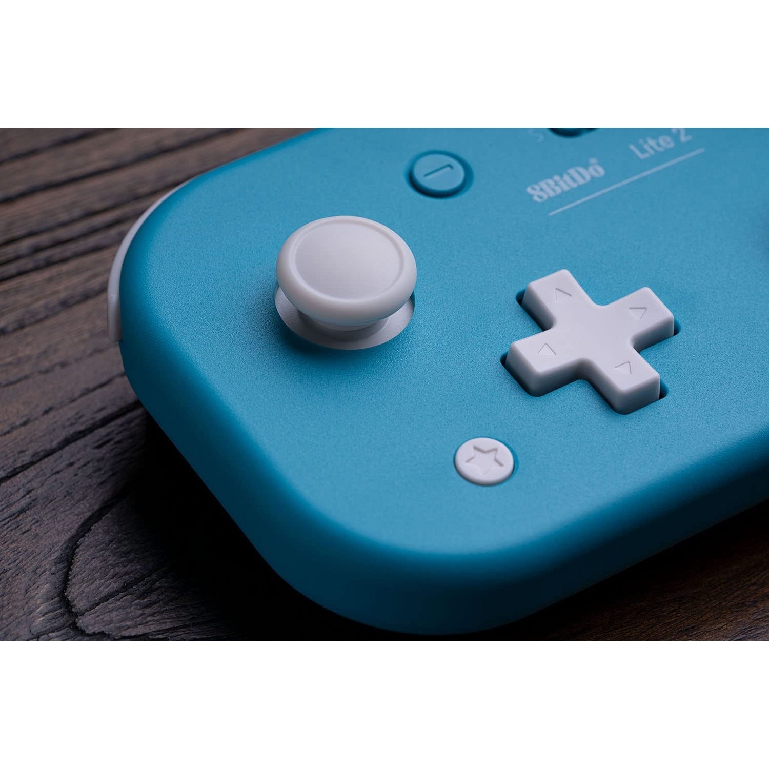 Macro close-up of 8BitDo Lite 2 joystick and D-pad in turquoise finish.